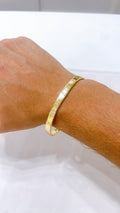 18K Gold Screw Bangle Bracelet worn on a wrist showcasing its sleek design and polished finish.