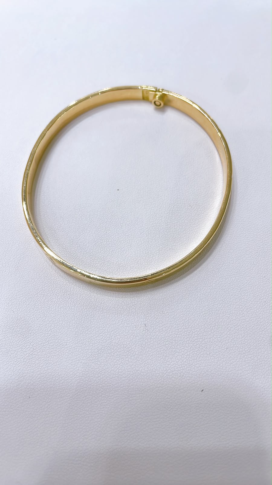 18K Gold Screw Bangle Bracelet showcased on a white background, highlighting its sleek and polished finish.