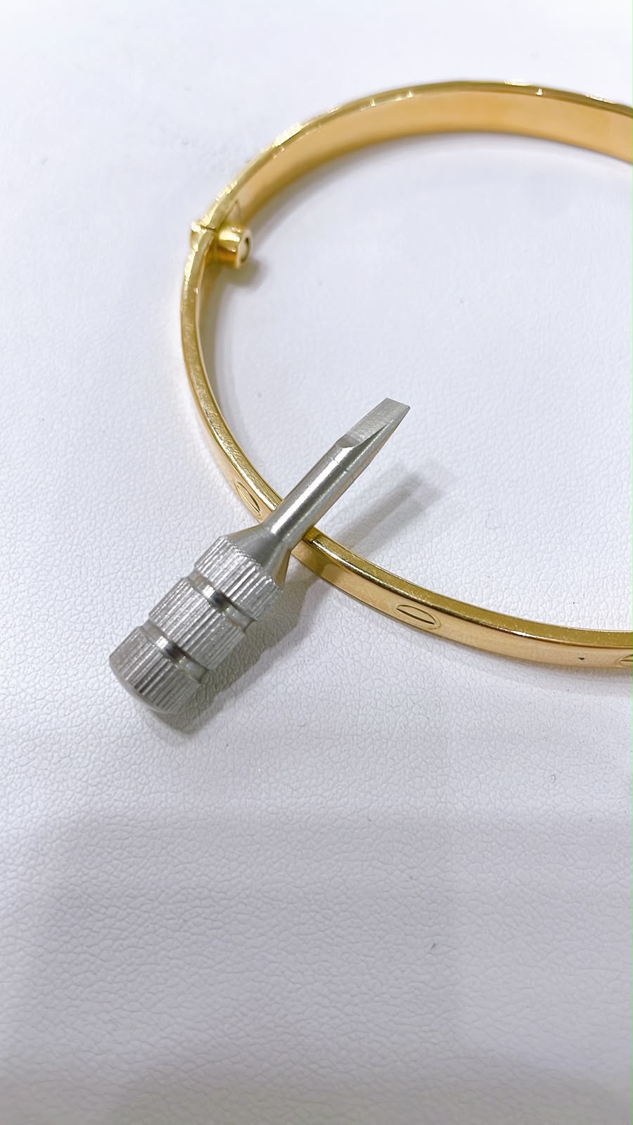 18K Gold Screw Bangle Bracelet showcasing a sleek design with a distinctive screw detail.